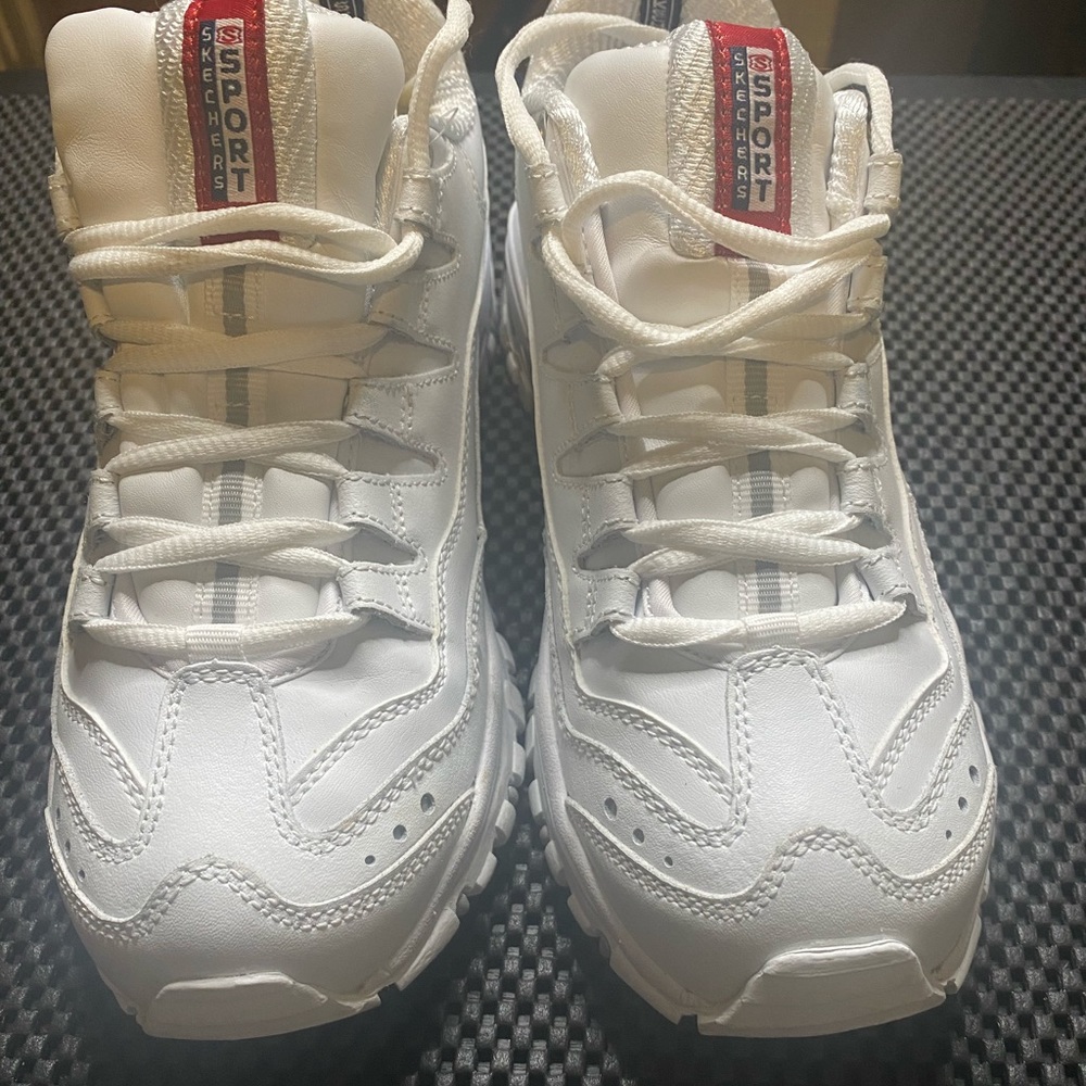 Sketchers sneakers. White gym shoes, and trendy.